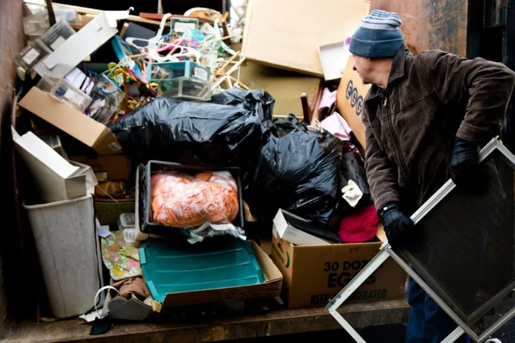 Frisco TX resident loading junk in 10 Yard size dumpster